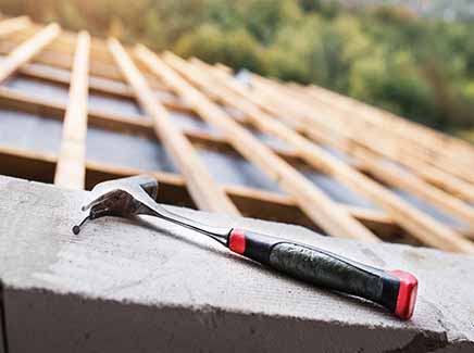 The image shows a close-up of a section of a residential roof with brown tiles that appear to be in good condition. A person's hand wearing a glove is visible, reaching into the image and touching the tiles, possibly indicating that they are examining or repairing the roof. The text "West Palm Beach Roof Repair - Fix Roof" is written in large letters across the image, indicating that E.W. MacDowell Roofing offers roofing repair services in the area. The image is intended to convey the company's attention to detail and expertise in fixing roofing issues for their customers.